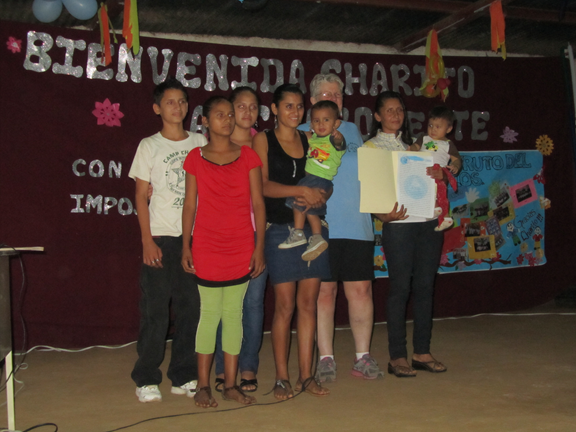 Rosaura and her family accept the deed to their land.